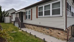 A single-story mobile home with a front porch, a brick foundation, and a small front yard. - Short walk to the beach * Montego Bay;Ocean City, MD (Ocean City)