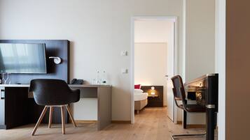 Deluxe Suite, 1 Bedroom | Living area | 28-inch flat-screen TV with satellite channels, TV, pay movies