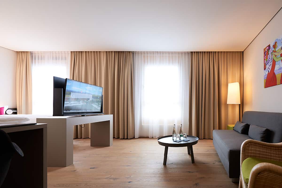 junior suite, 1 bedroom | living area | flat-screen tv, pay films