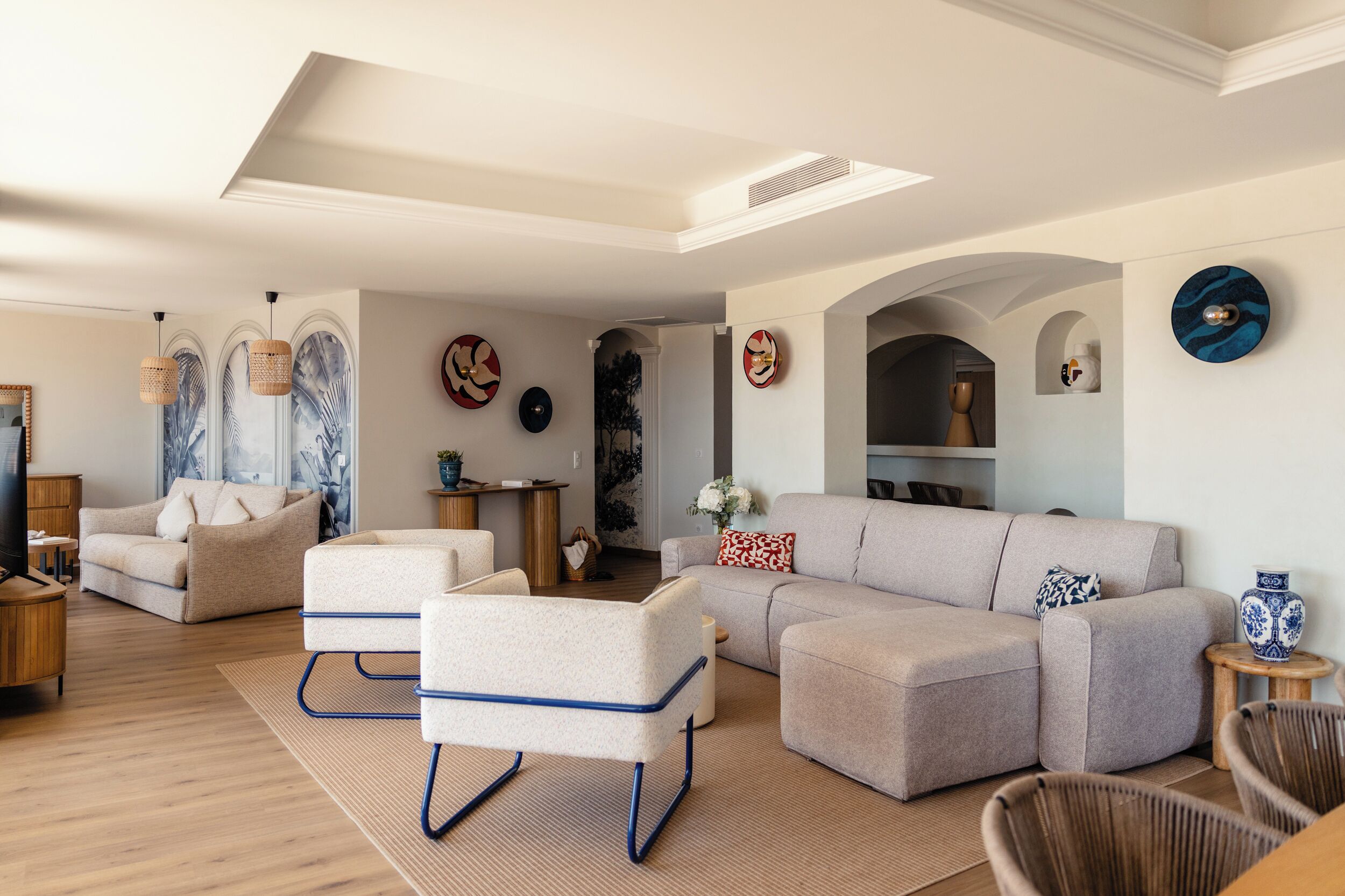 A modern living room with a sectional sofa, a small coffee table, and a television on a wooden stand.