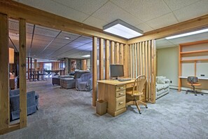 Work and unwind in this open-plan office space with a central desk, comfortable seating area, and workspace.