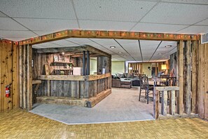 Relax in a rustic-style space with a central bar area, sofa, and comfortable seating.