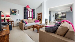 A modern living room with a sofa, coffee table, and a dining area visible in the background. - Villa Clariss (Visnjan)
