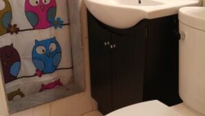 A bathroom with a toilet, a sink, and a cabinet. - Suites of Wasaga Beach Area 2- mins walk Beach 1 (Wasaga Beach)