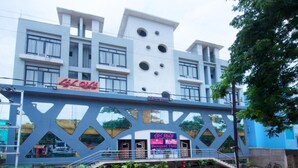 A modern building with a unique geometric facade, a visible entrance, and a sign indicating a banquet hall. - Hotel Lal Qila (Bhubaneshwar)