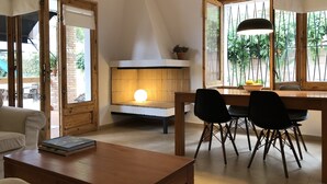 A cozy dining area with a table, chairs, and a modern fireplace.
