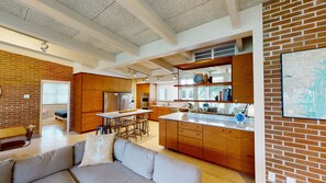 A modern kitchen with wooden cabinets, stainless steel appliances, and a large island. - Duneside 5 bedrooms, 5 bathrooms (Jekyll Island)