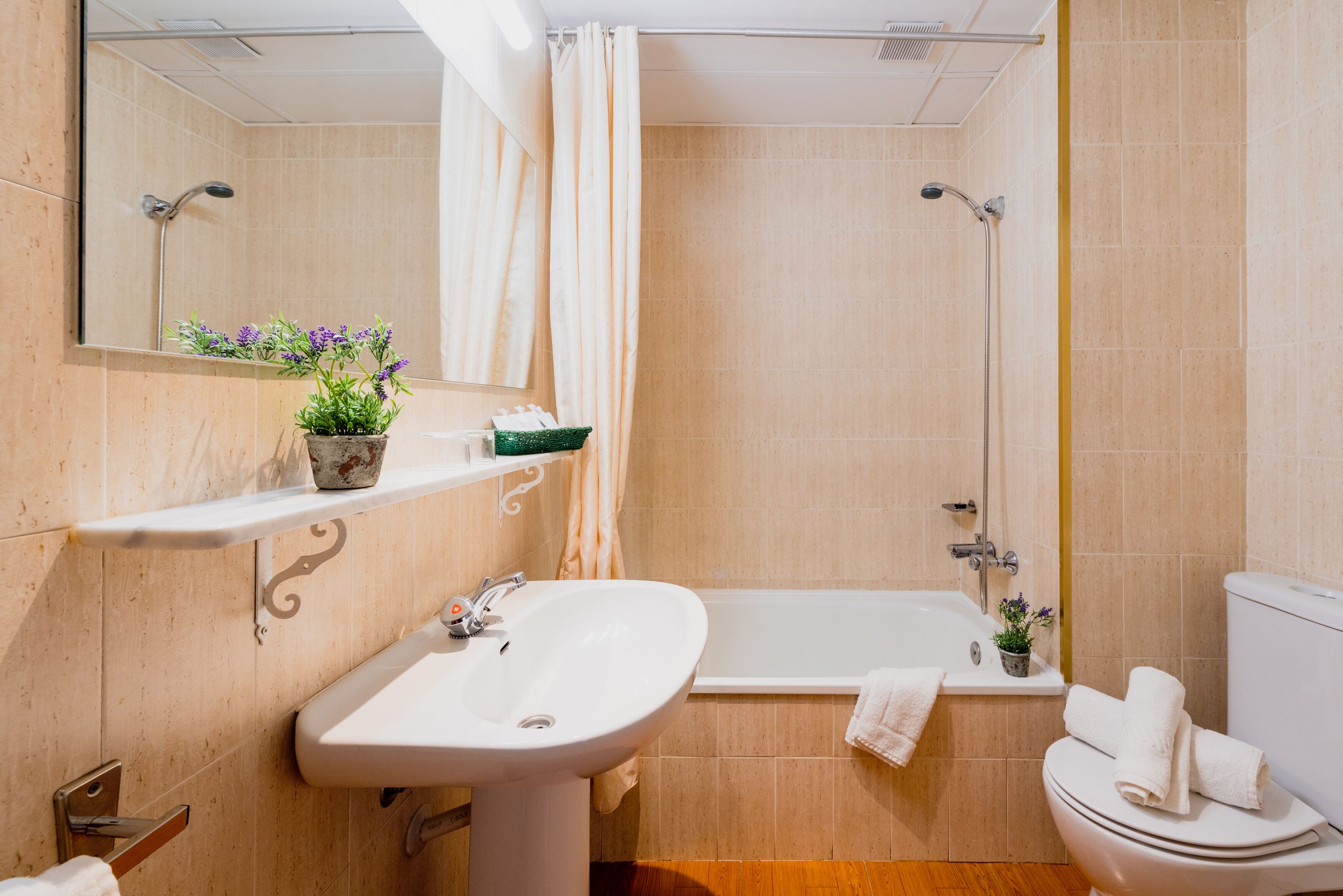 A bathroom with a sink, toilet, and bathtub.