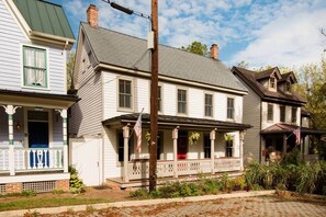 A two-story house with a porch, a chimney, and a flagpole. - Wren Retweet- Country Estate in Center of C’Town (Chestertown)