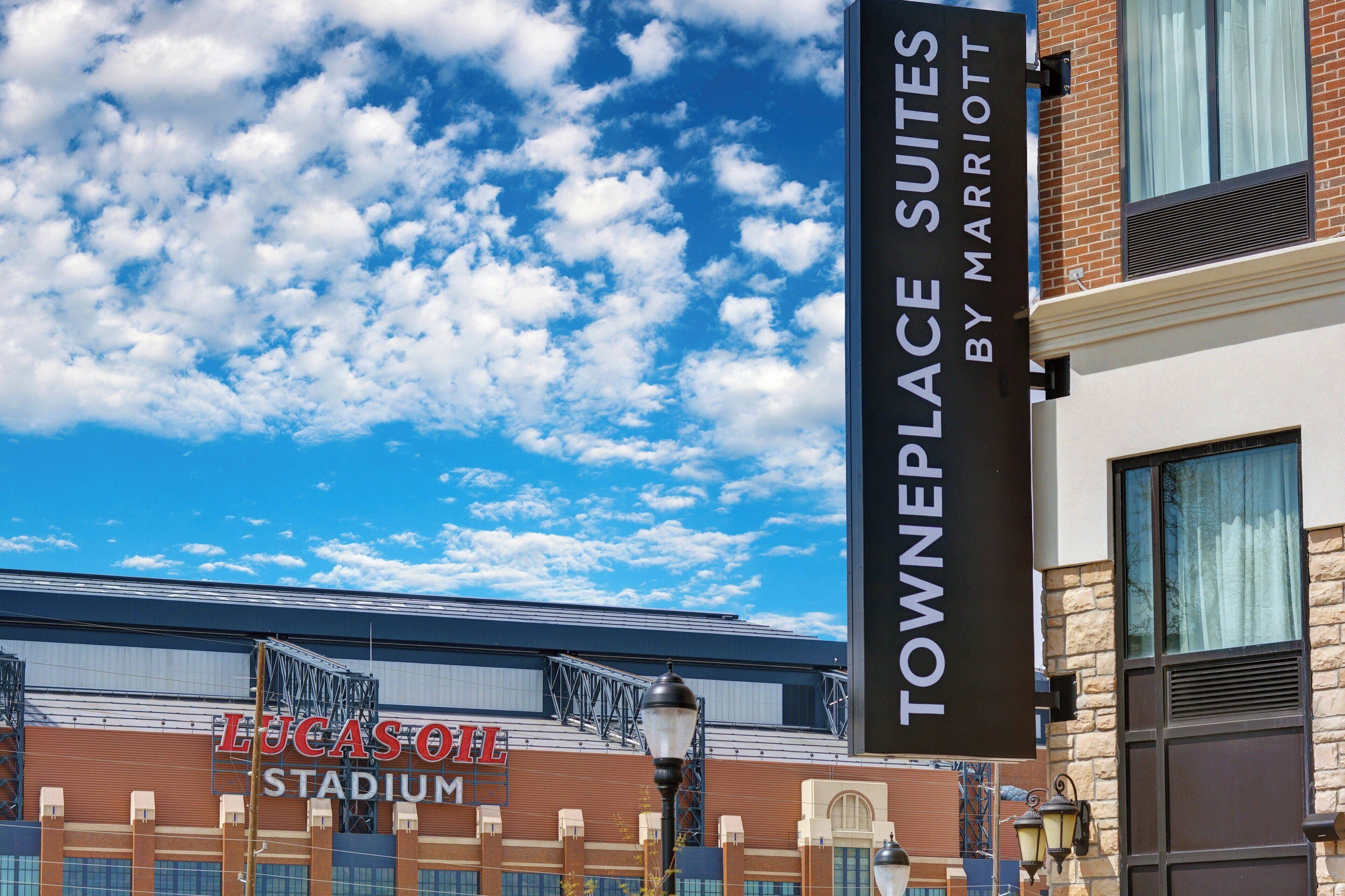 A sign for TownePlace Suites by Marriott and Lucas Oil Stadium.