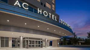 A hotel entrance with a modern design, featuring a large illuminated sign that reads "AC HOTEL SOUTHPOINTE." - AC Hotel Pittsburgh Southpointe (Canonsburg)