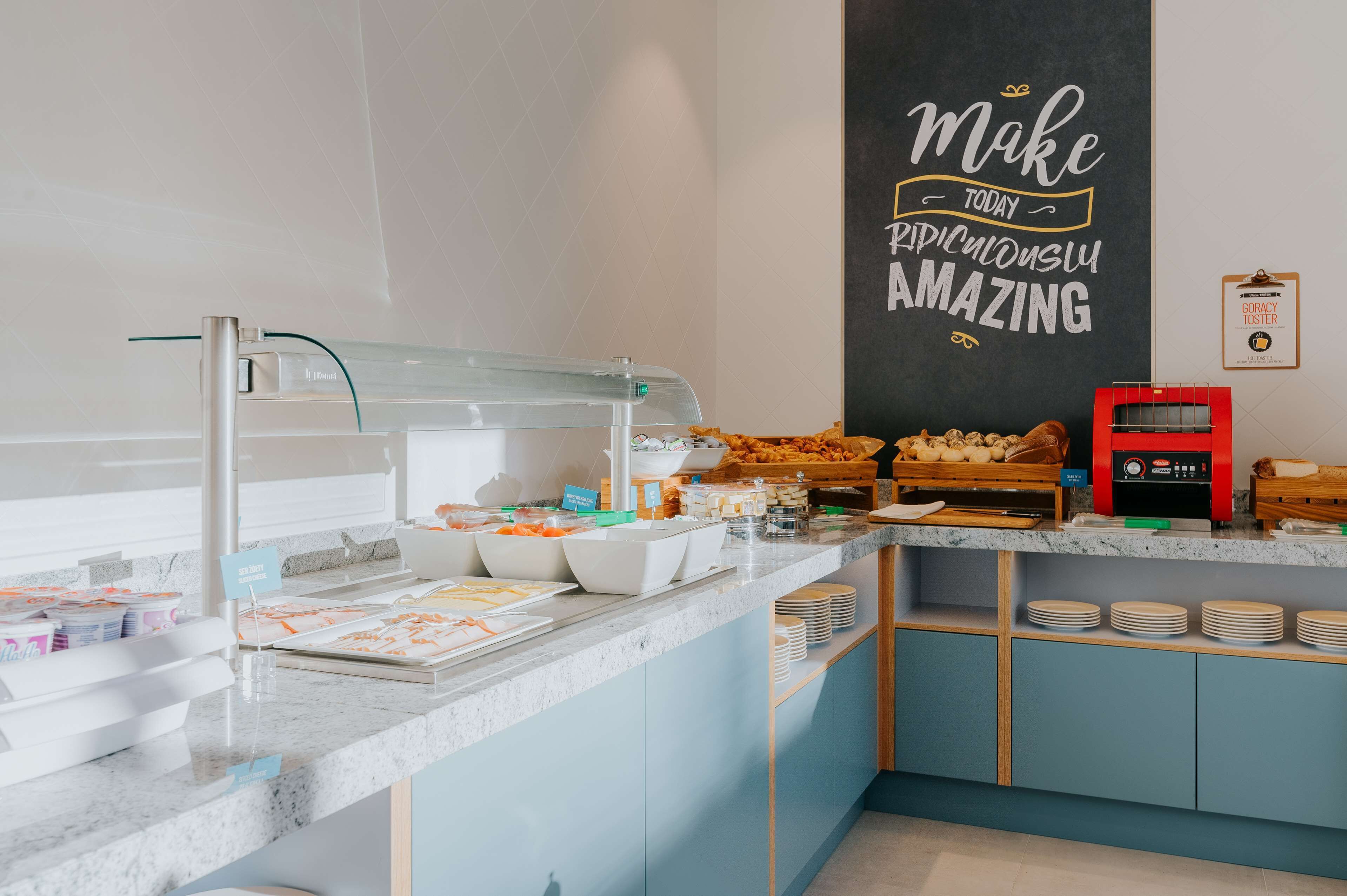 A breakfast buffet with various food items and a coffee machine.