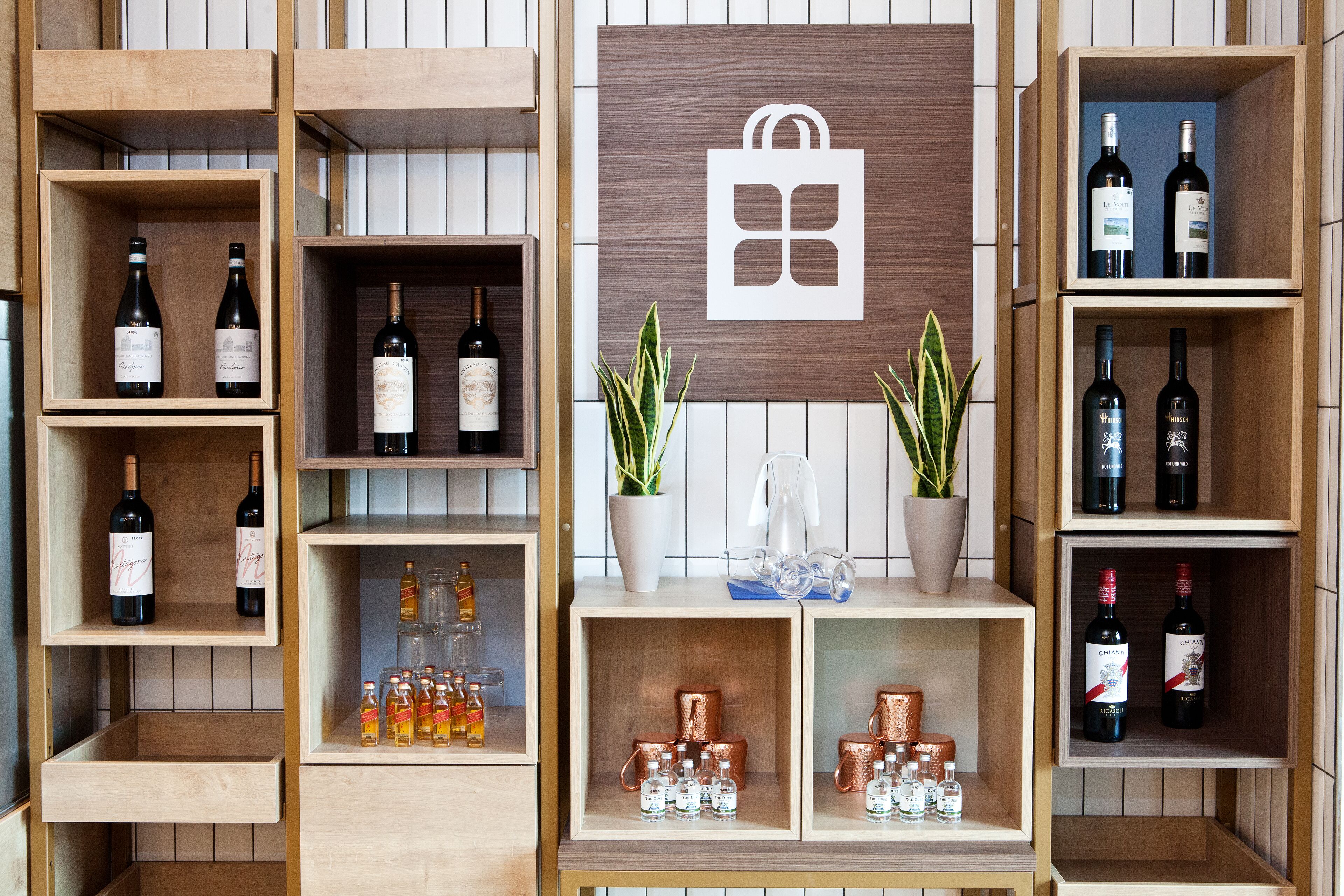 A wine display with shelves and a central wooden panel with a logo.