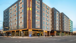 A modern hotel with a prominent 'Home 2 Suites' sign, multiple floors, and a well-lit facade. - Home2 Suites By Hilton Boise Downtown (Boise)