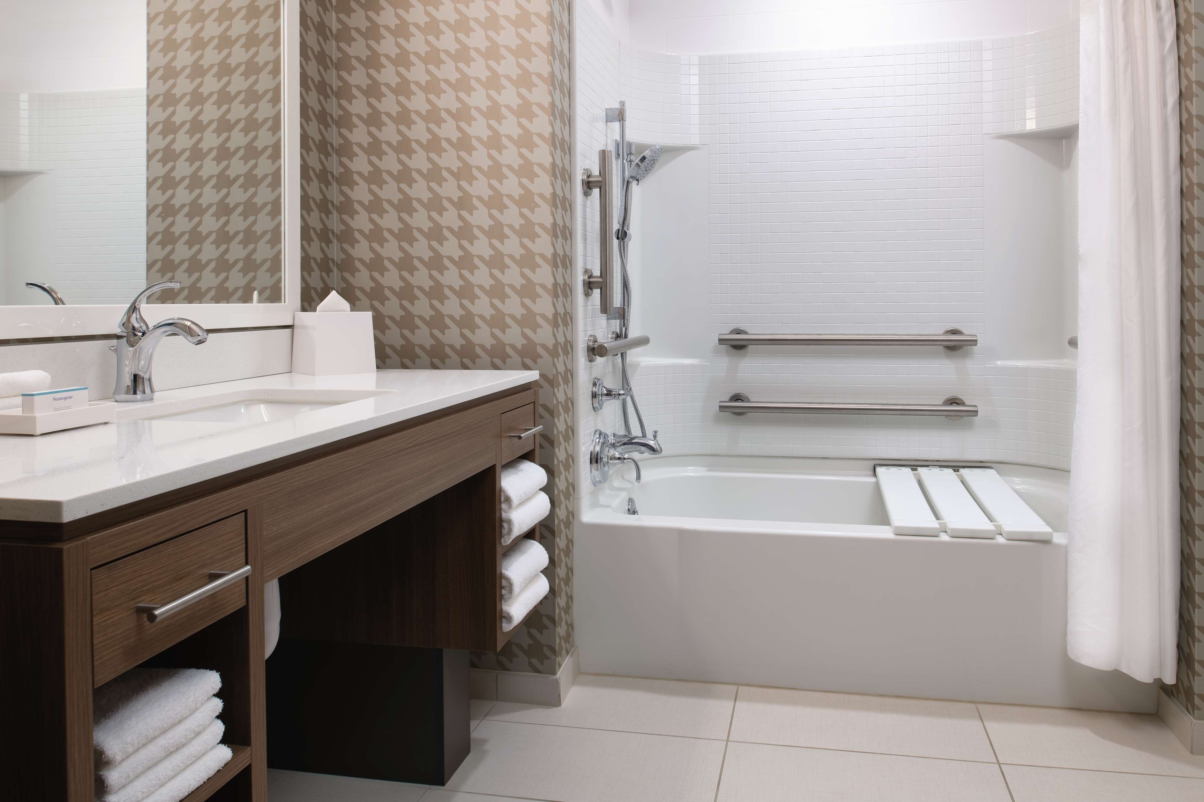 A modern bathroom with two sinks, a mirror, a shower, and a bathtub.