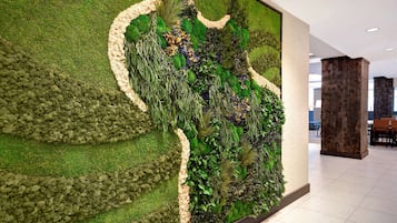 A modern interior with a large wall mural of a lush garden.