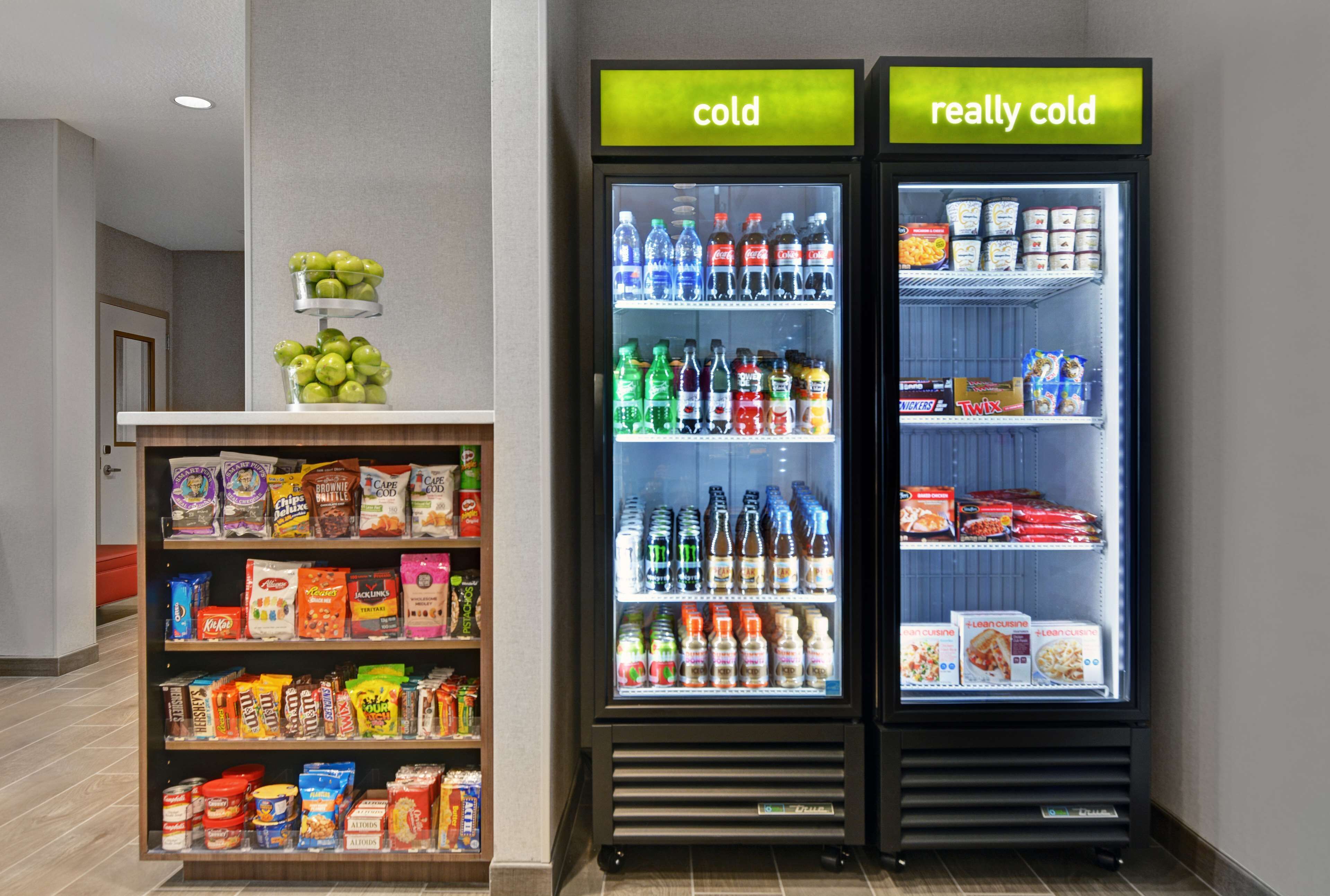 A vending machine with 'cold' and 'really cold' sections, stocked with beverages and snacks.