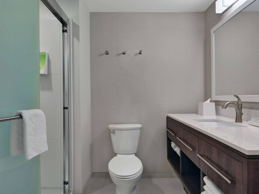 Un bagno con il water, un lavandino e uno specchio.