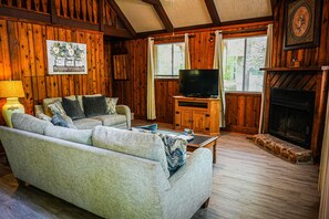 Cozy living room with a comfortable sofa, fireplace, and flat-screen TV.