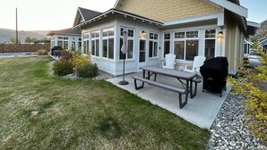 A house with a covered patio, a barbecue grill, and outdoor seating. - OSOYOOS PRIVATE RESORT HOME STEPS FROM THE LAKE (Oliver)
