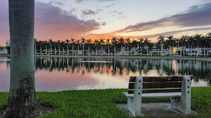 A bench by a calm lake with a sunset in the background. - 2BR Golf View | Near St. Pete Bch (St. Petersburg)