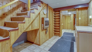 Un escalier en bois, dont les marches sont recouvertes de moquette, mène à un palier.