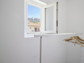 Guests can enjoy a view of the city from the open window.