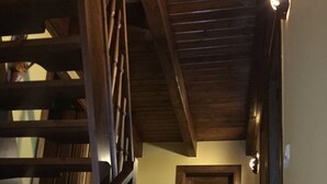 A wooden staircase with a handrail leading to a closed door at the top.