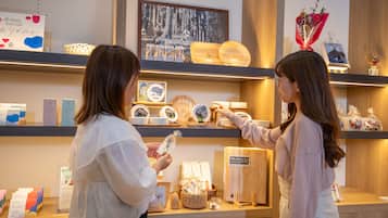 A retail display with various items on shelves, including framed pictures, wooden objects, and decorative items.