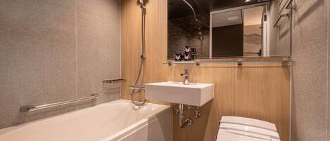 A modern bathroom with a bathtub, a sink, and a toilet.