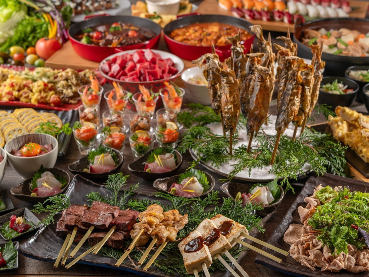 A variety of food items including skewered meats, seafood, and vegetables, arranged on a table.