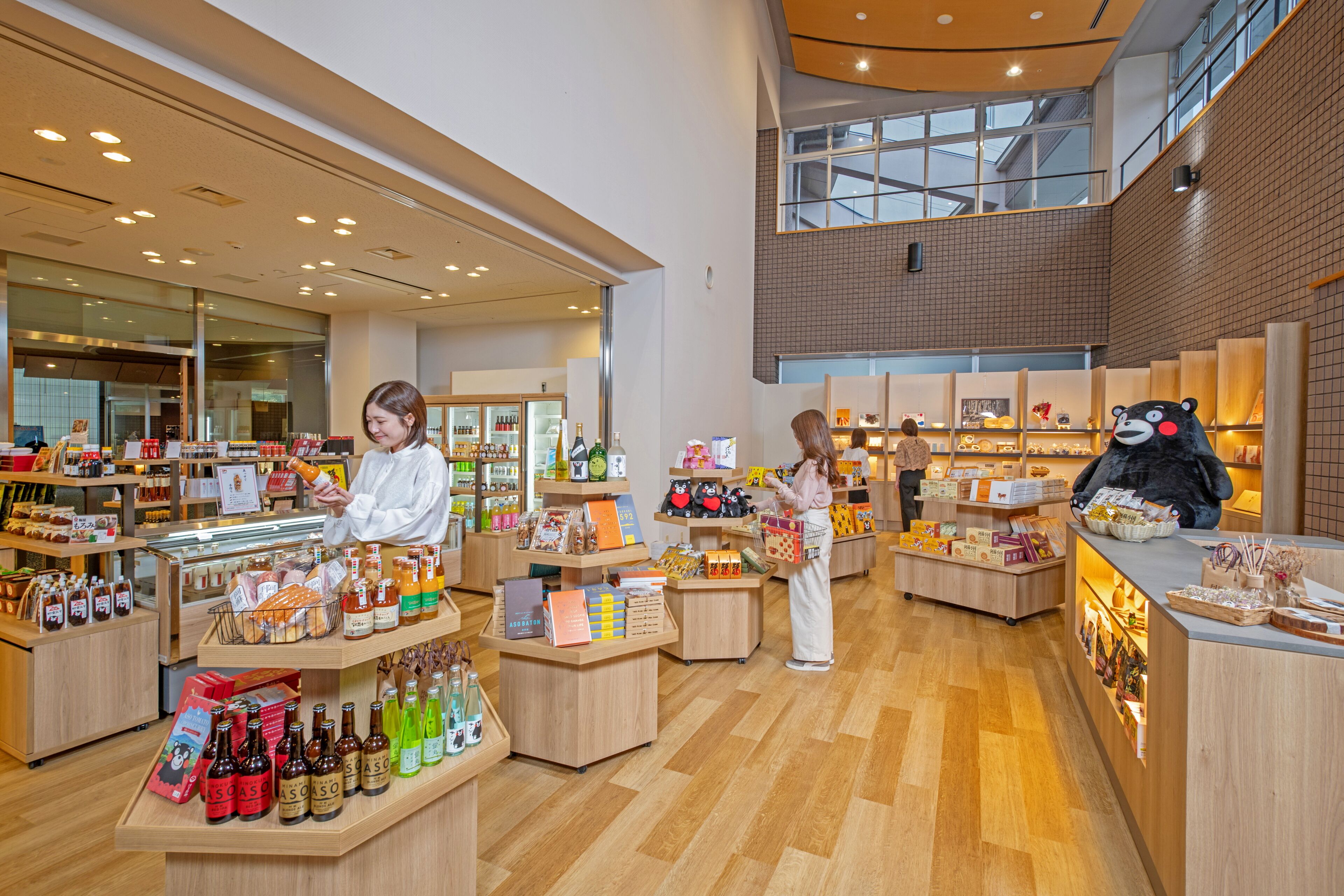 A spacious, well-lit store with wooden flooring and a variety of products on display, including bottles and boxes.