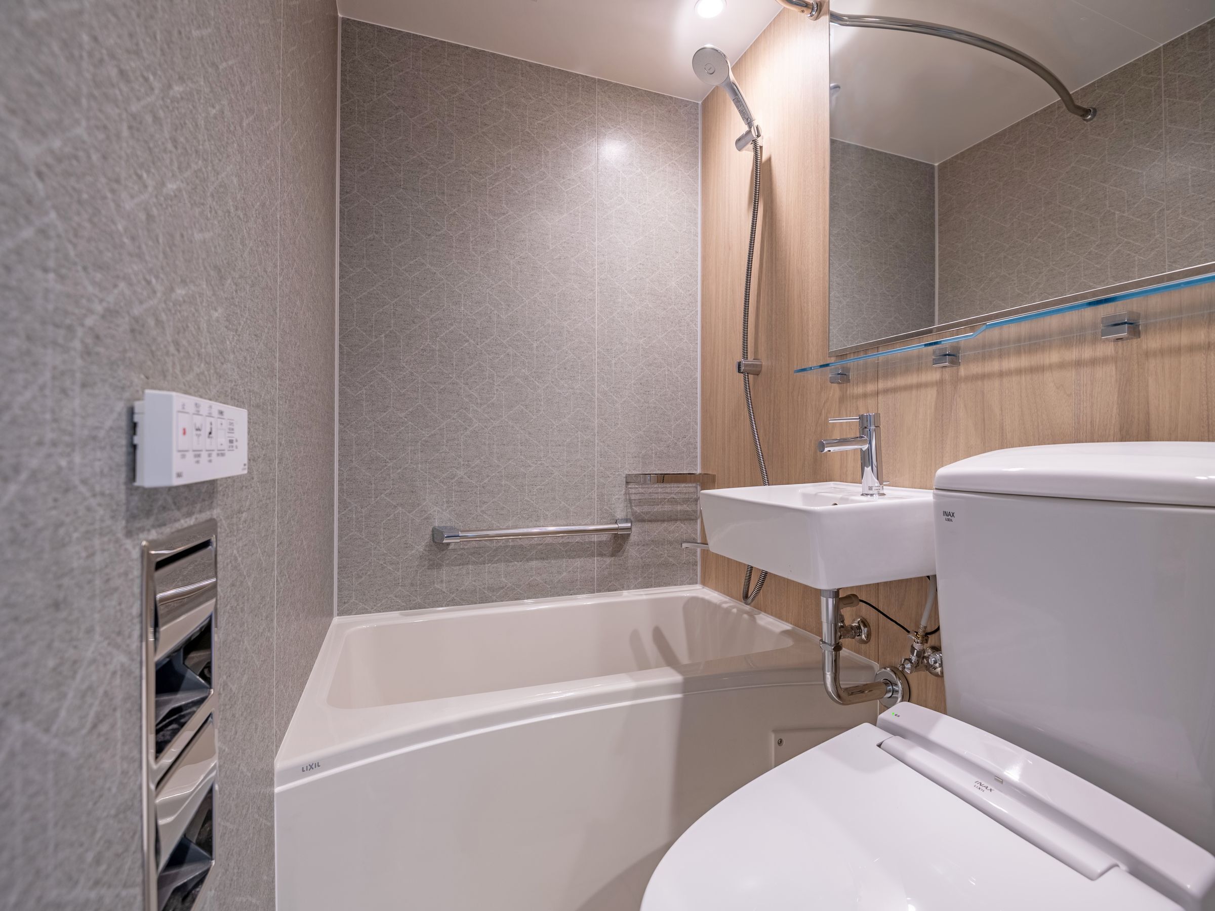 A modern bathroom with a bathtub, a toilet, and a sink.