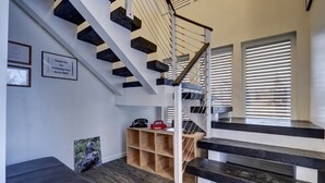 A modern staircase with a metal railing, wooden steps, and a built-in shoe rack. - 4 Master Suites in the Heart of Alaska...Abby's Place..... (Palmer)