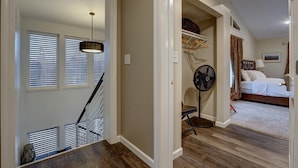 A bedroom with a bed, a standing fan, and a window with blinds. - 4 Master Suites in the Heart of Alaska...Abby's Place..... (Palmer)