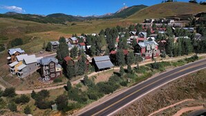 A residential area with houses, a road, and a mountain in the background. - The Surf Shack, On shuttle route, EV charger (Crested Butte)