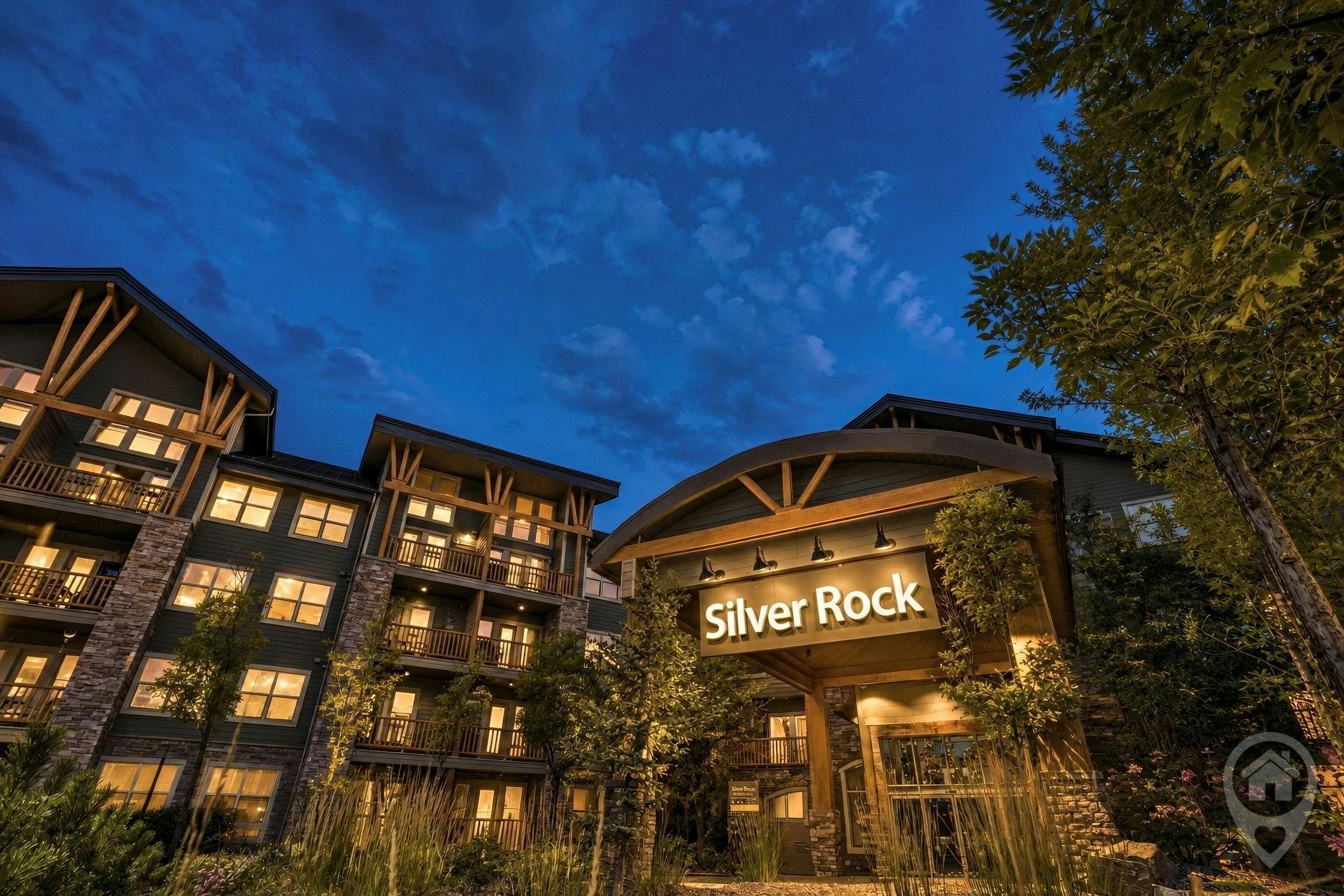 Un hôtel à plusieurs étages, reconnaissable à son grand panneau « Silver Rock », à ses balcons et à sa façade en pierre.