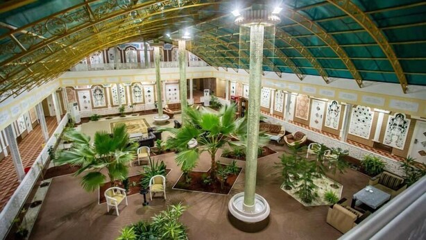 A spacious atrium with a high ceiling, multiple seating areas, and decorative columns. - Reikartz Modarixon Bukhara (Bukhara)