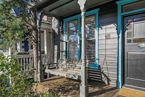 A wooden porch with a bench, a metal railing, and a blue door. - Abode at Watson House, private hot tub, walk to town lift & Main Street (Park City)