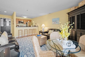 Relax in this stylish living space with comfortable seating and a fully equipped kitchen area.
