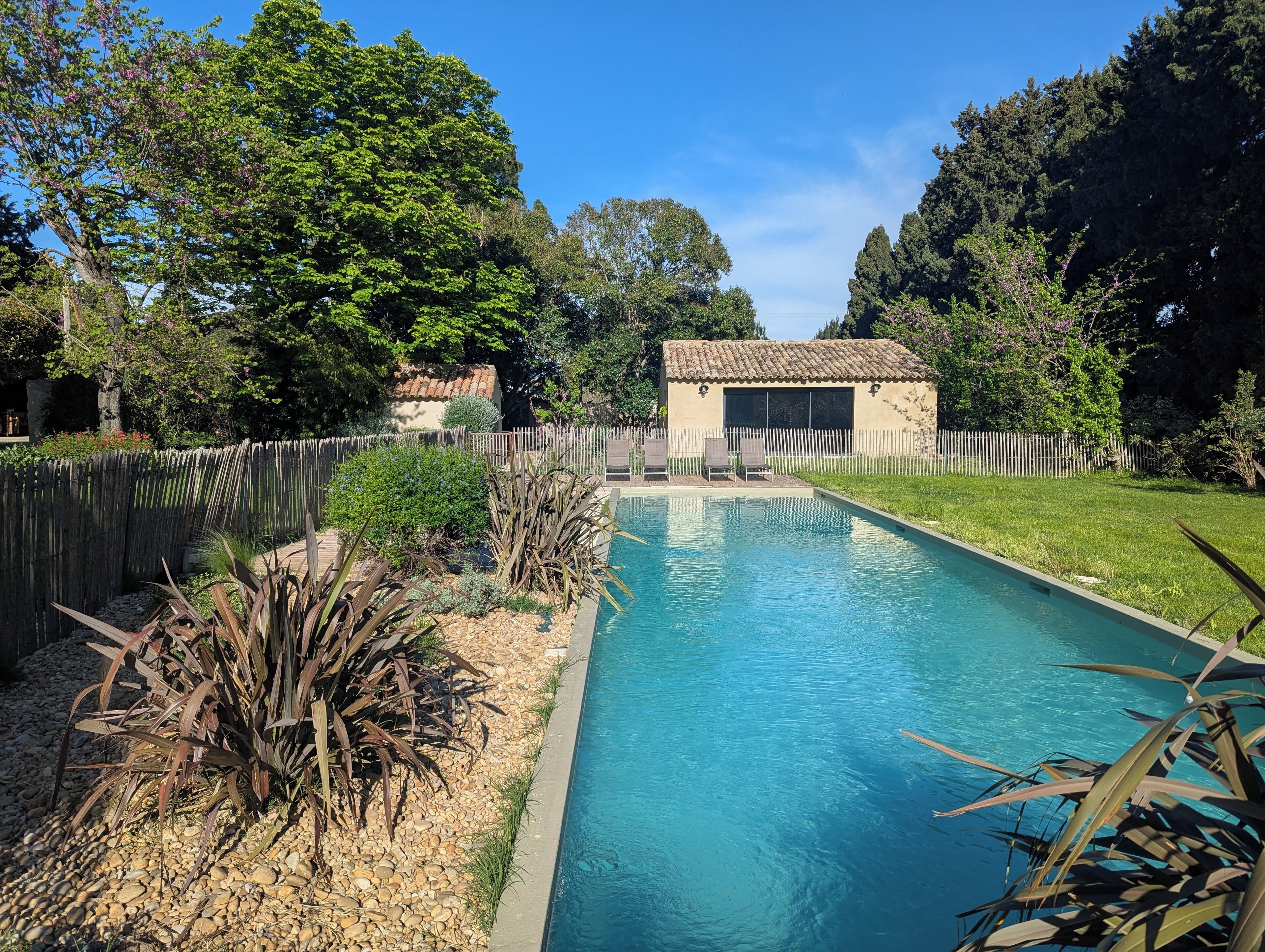 Una piscina al aire libre de temporada, sillones reclinables de piscina