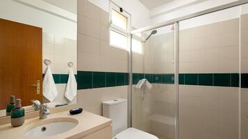 Bathtub, hair dryer, towels, toilet paper
