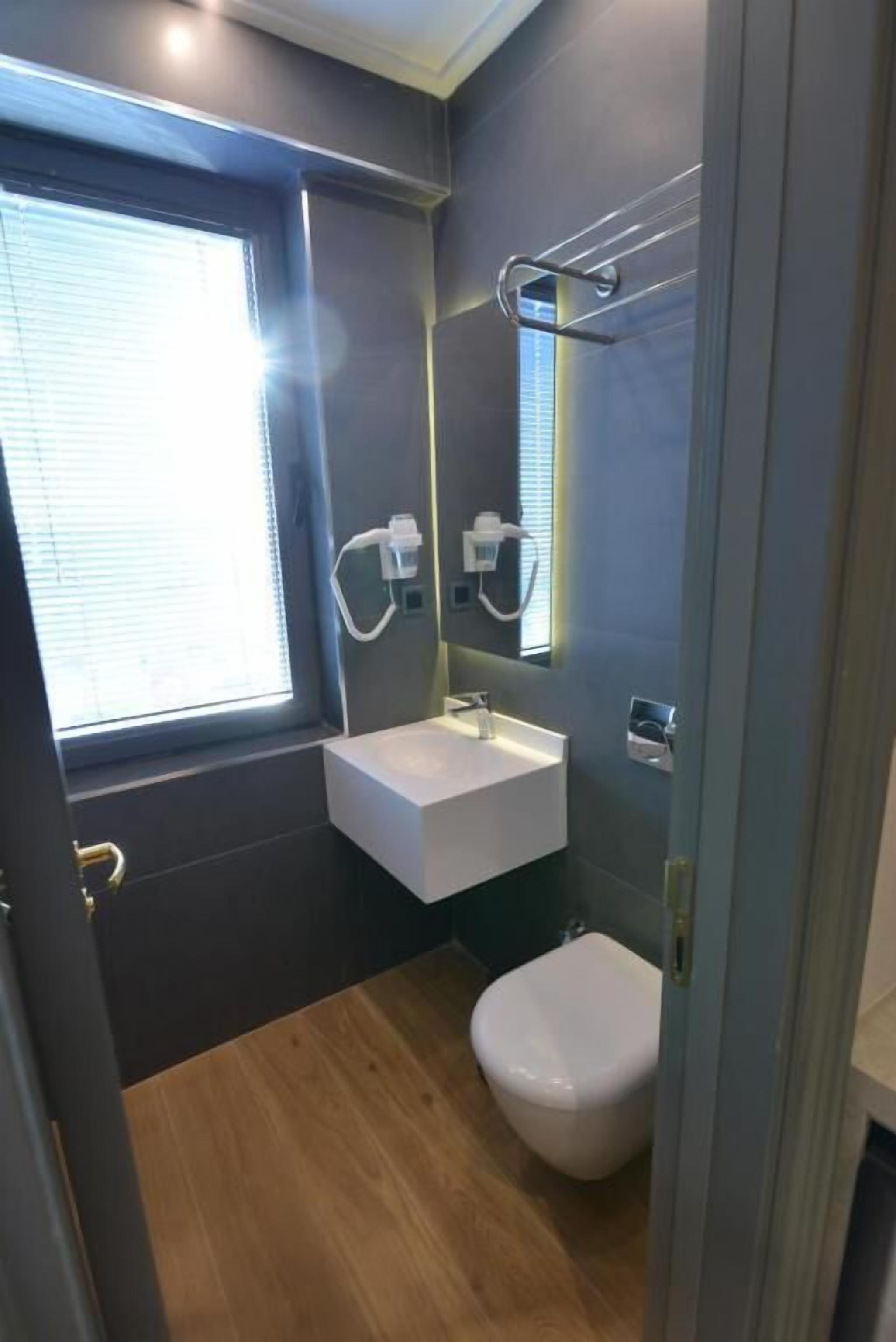 shower, hair dryer, slippers, towels