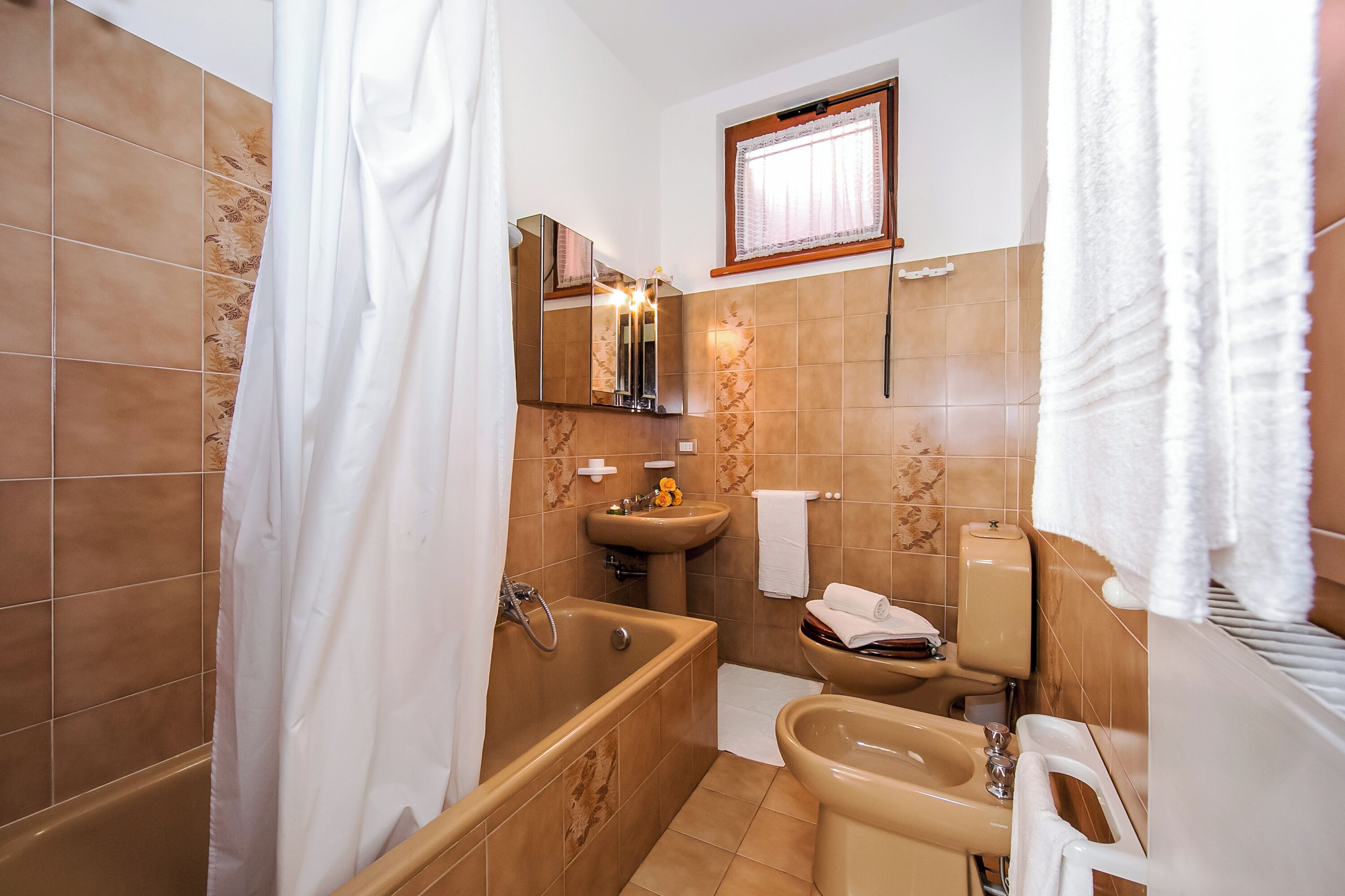 A bathroom with a bathtub, sink, and toilet.