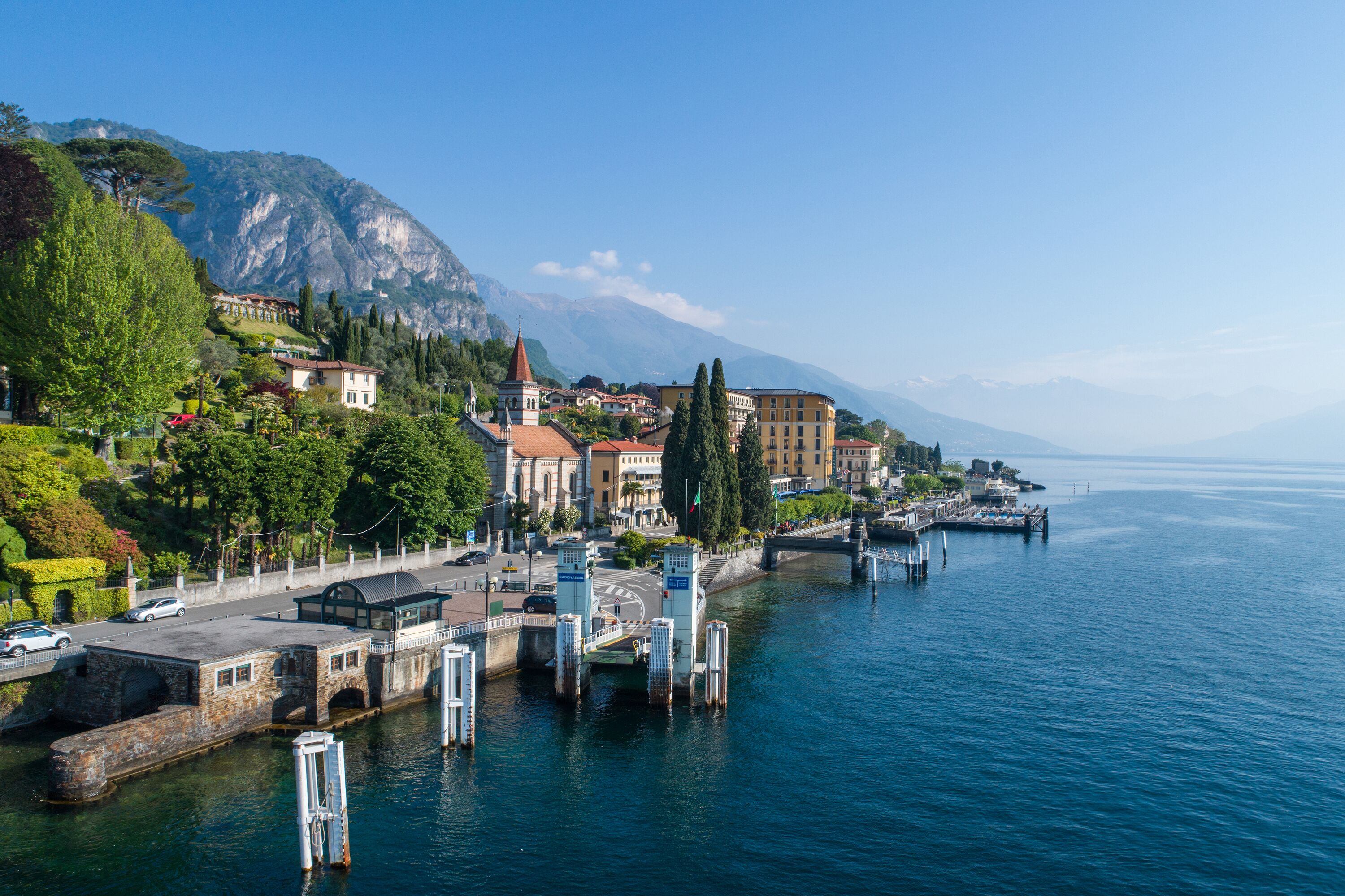 A waterfront town with a prominent church, a bridge, and a dock area.