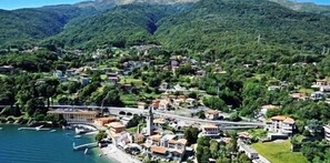 A coastal town with a mix of residential and commercial buildings, a bridge, and a body of water.