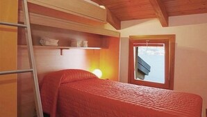 A single bedroom with a bunk bed, a ladder, a window with a view, and a wooden ceiling. - Le Vele Terrazzo (San Siro)
