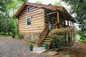 A wooden cabin with a porch, a staircase, and potted plants. - Touche' Too Cabin by Buffalo Mtn Getaway (Meadows of Dan)