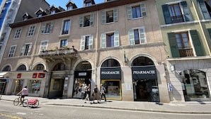 A building with multiple storefronts, including a pharmacy.
