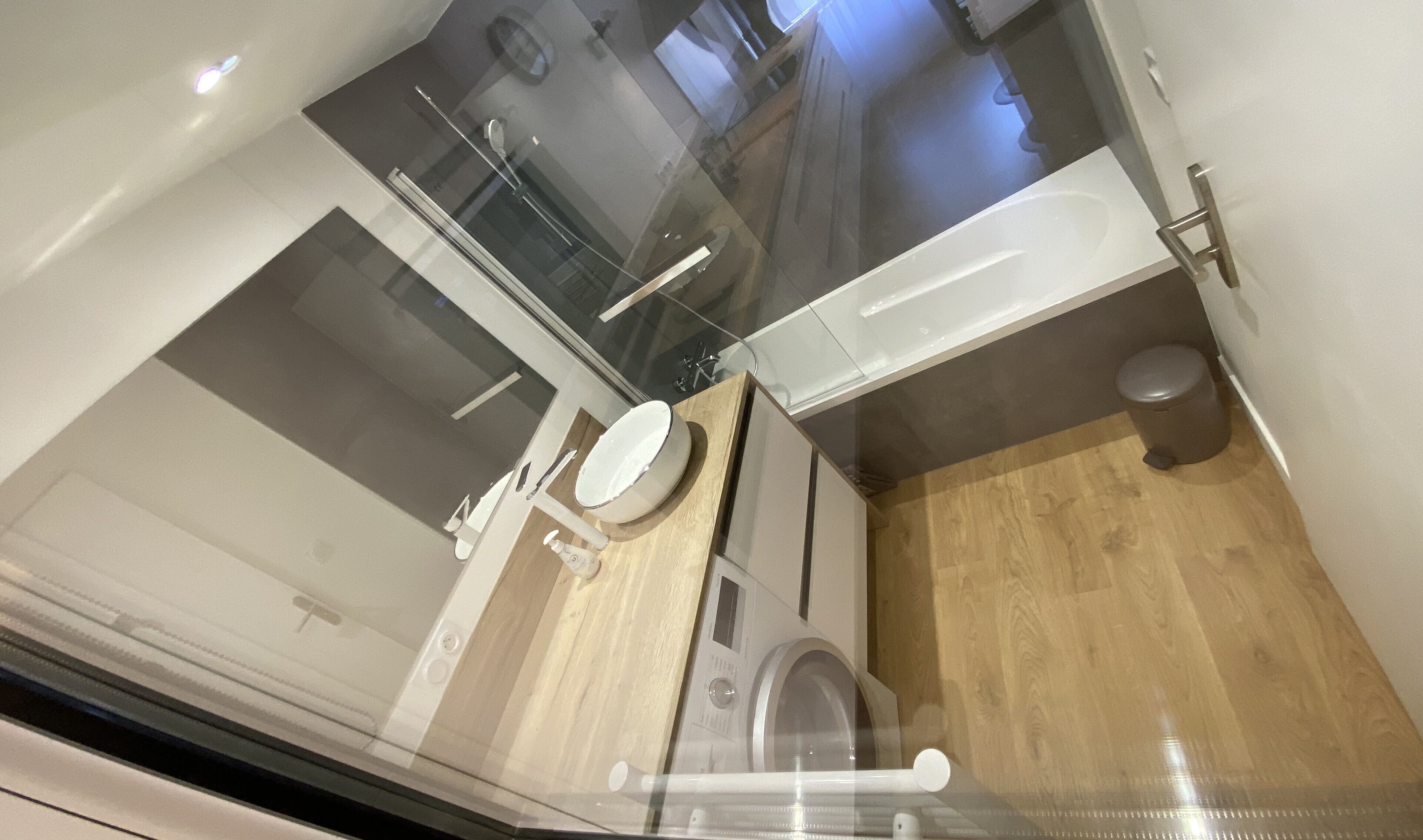 A compact bathroom with a toilet, sink, and shower area.